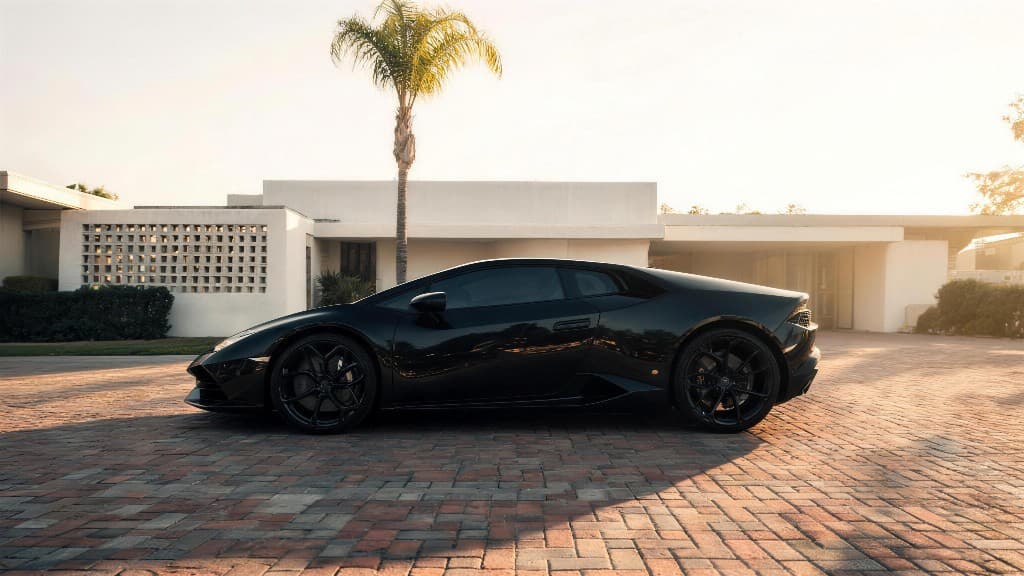 Lamborghini Huracán on the estate driveway on arrival, gloss black